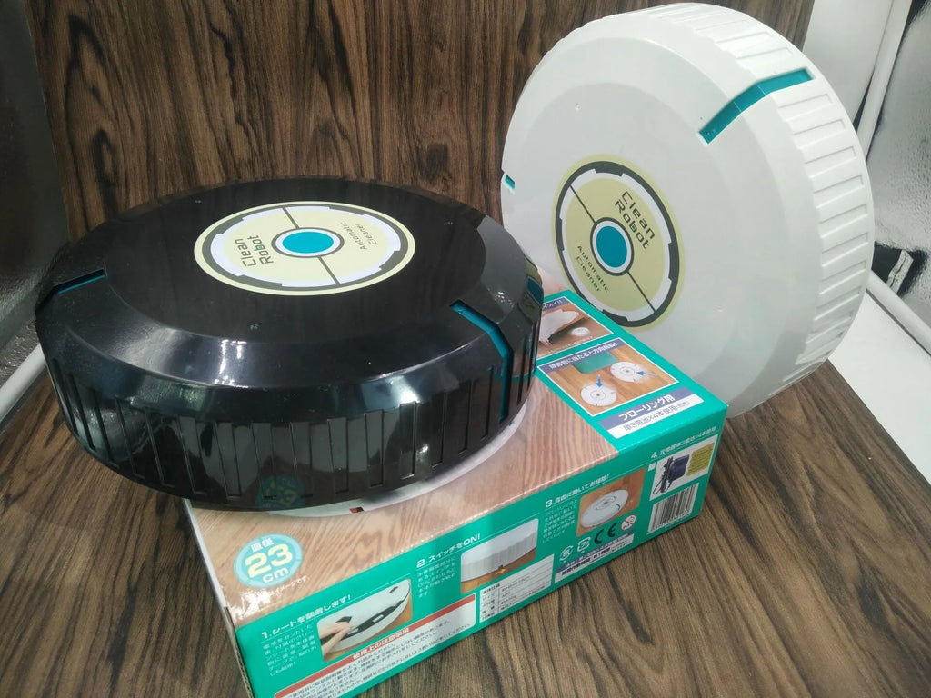 Black or white AC-powered robot vacuum cleaner on a wooden floor.