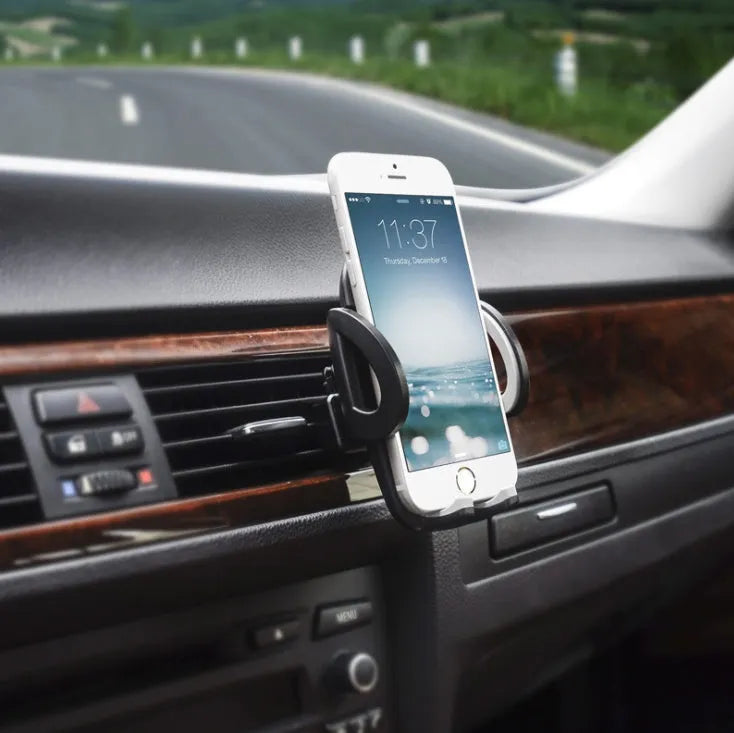 Black plastic mobile phone holder mounted on car air conditioning outlet vent