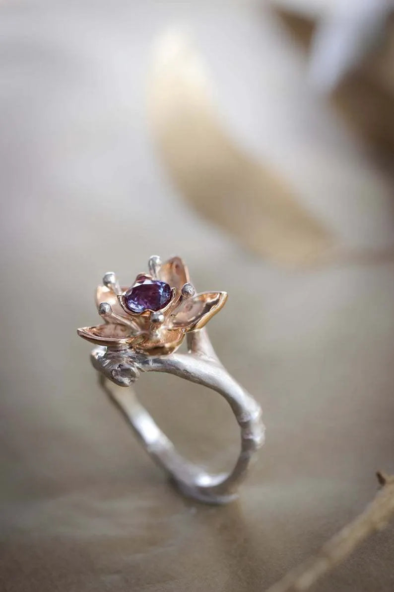 Silver two-tone floral geometric pattern alloy ring for women on a white background.