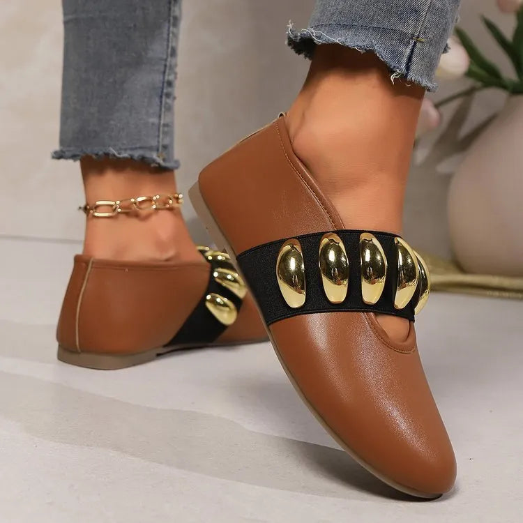 Women's brown flat loafers with metal buckle and round toe on artificial PU upper