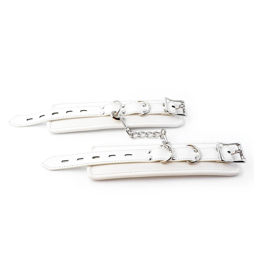 White PU sponge bondage set showing soft handcuffs, foot cuffs, and a neck cuff.