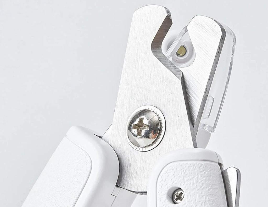 White LED pet nail clippers for cats and dogs with open transparent safety guard and nail file.