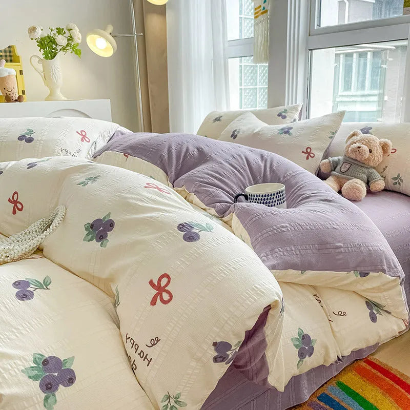 Aerobic jacquard cloud yarn four-piece bedding set with quilt cover, sheet, and pillowcases in a soft pattern.