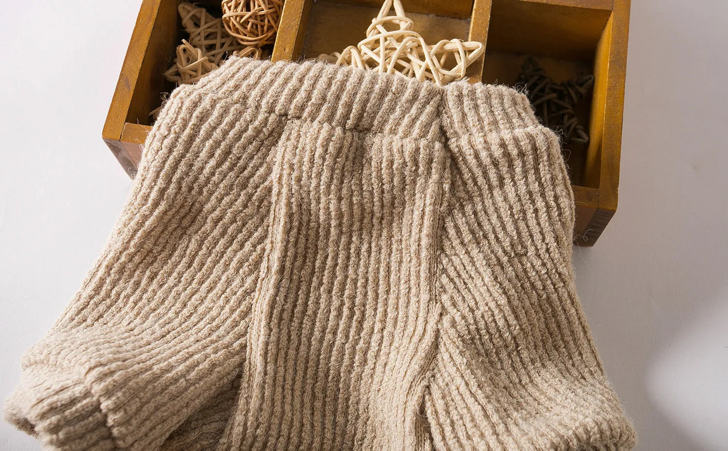 Brown knitted pullover sweater on a small dog, showing casual cloth design.