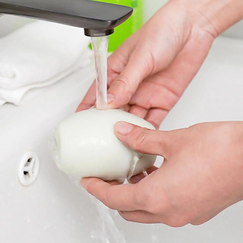 Green and white washable reusable gel lint roller balls for portable pet hair removal.