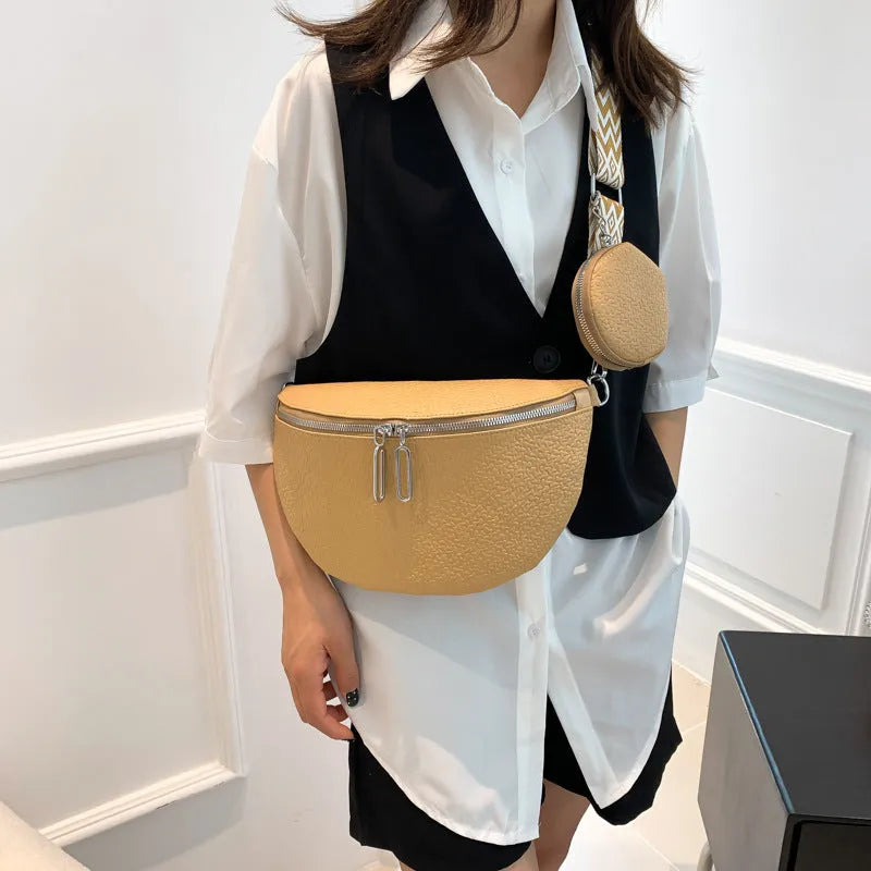 Solid colour women's crossbody bag with saddle lock detail, shown in a horizontal square clamshell shape.