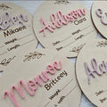 Square wooden name plaque engraved with newborn birth details for nursery wall display