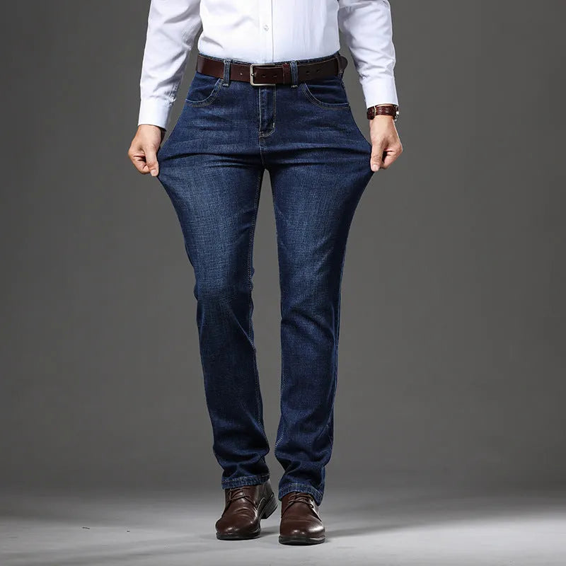 Straight leg stretch jeans in blue denim on a mid-waist model, showing zip fly and high elasticity fabric.