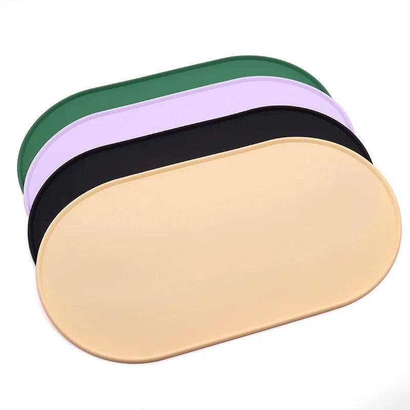 A green silicone placemat for cats with a non-slip base, shown under a food bowl.