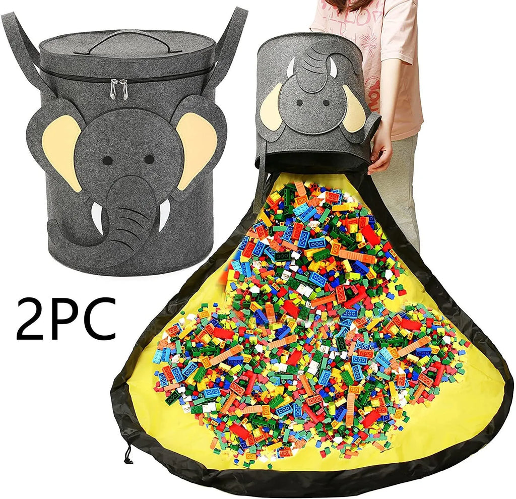 Green felt cube-shaped toy storage bag opened flat as a play mat next to toys, showing pull rope.