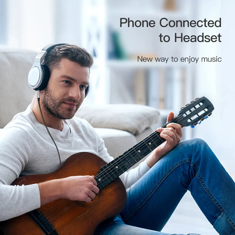 Silver and black headphone audio cable with 3.5mm jack for car stereo connection.