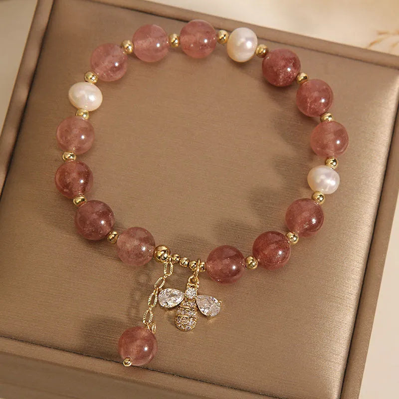 Women's bracelet with pink strawberry quartz stones, white freshwater pearls, and zircon details on an alloy chain.