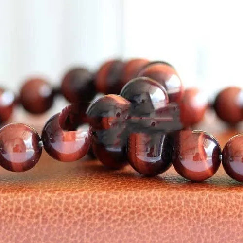 Handmade tiger's eye gemstone bracelet with lightning cat's eye pattern in geometric round beads