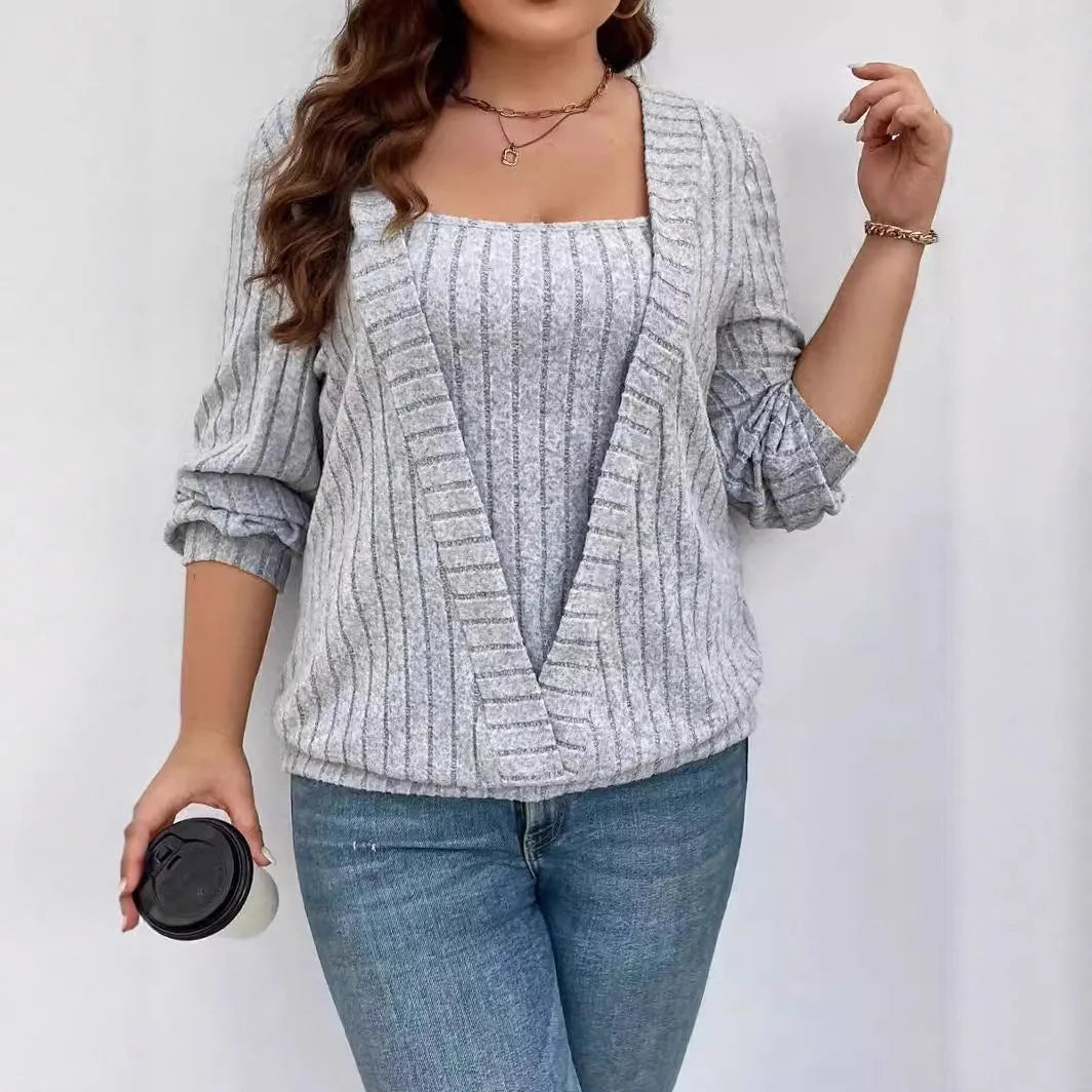 A woman wearing a solid purple rib fabric V-neck false two-piece suit with long sleeves and a loose fit.