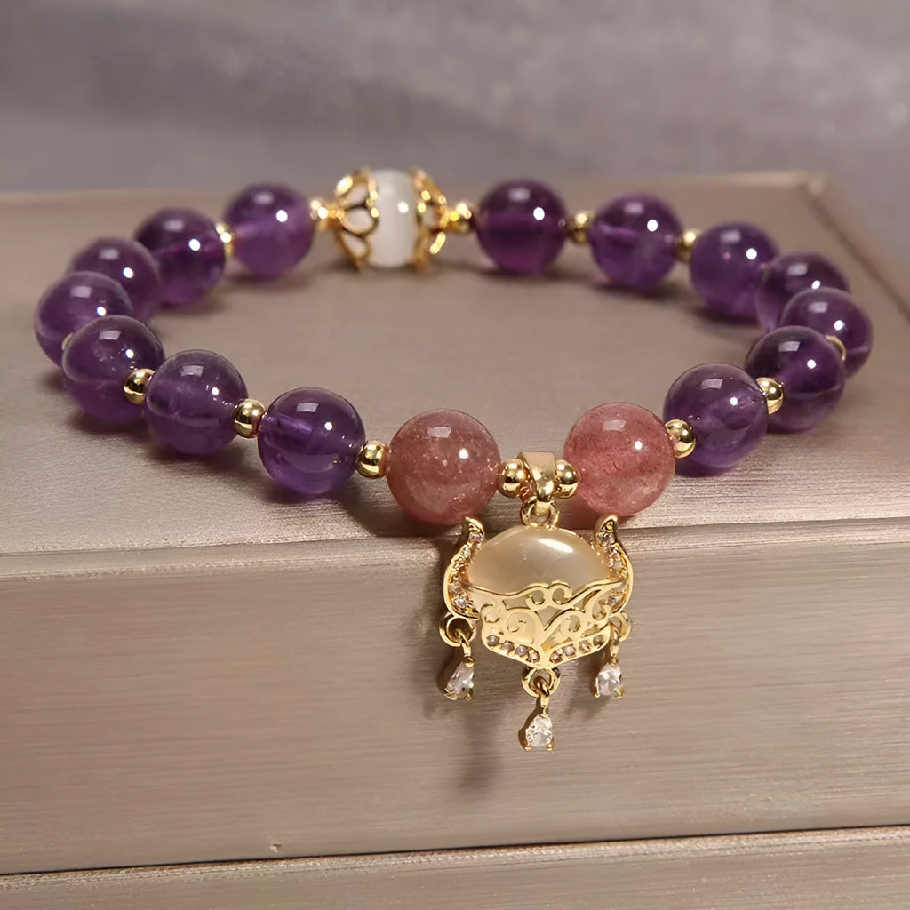 Handmade copper bracelet for women with a natural amethyst drop charm and longevity lock symbol.