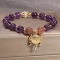 Handmade copper bracelet for women with a natural amethyst drop charm and longevity lock symbol.