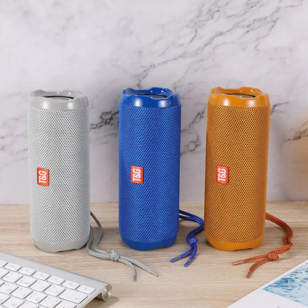 Fabric-covered portable Bluetooth speaker with integrated card holder in one of six colour options.