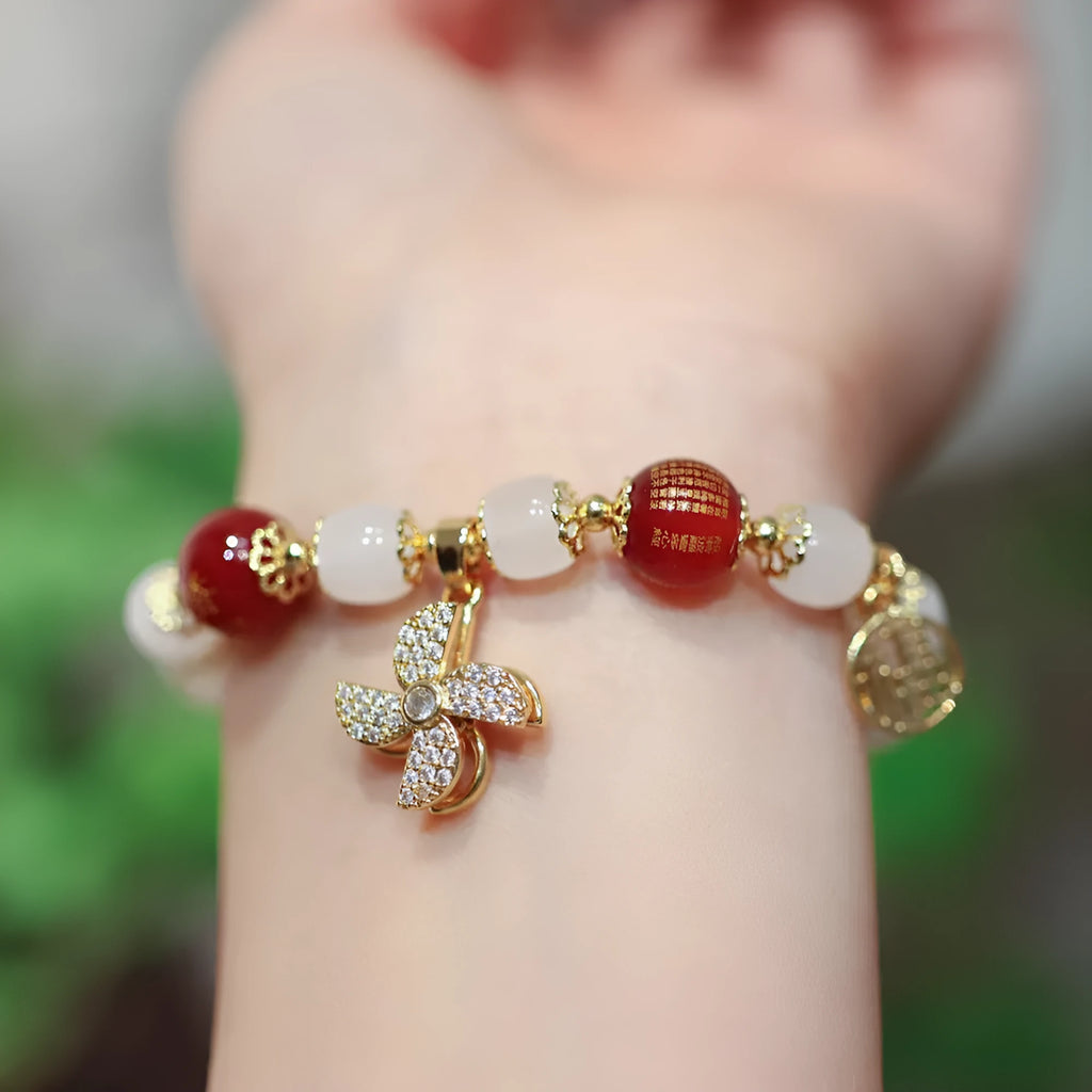 Chinese style women's glass bracelet with fu character and safety lock charms.