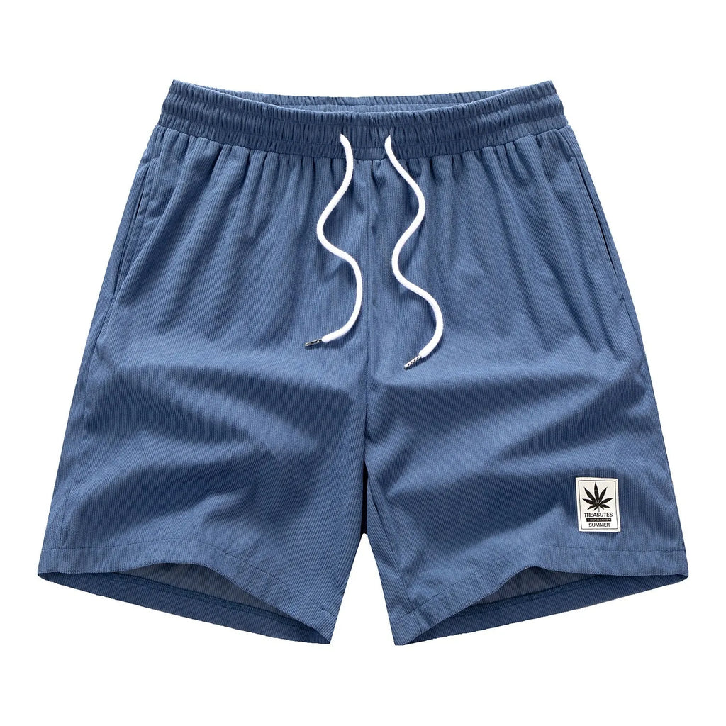 Man wearing grey straight leg drawstring summer shorts made from elastic fabric.