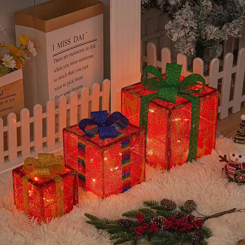 Set of three pre-lit Christmas gift box decorations with bows for outdoor holiday displays