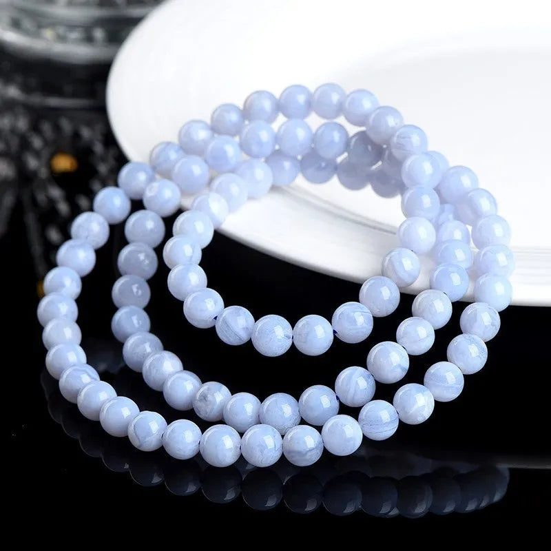 Blue agate beaded bracelet with striped patterning on 6-6.8mm beads in three circular strands