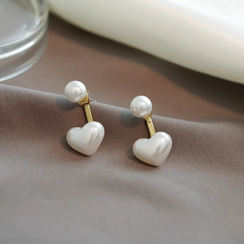 Heart-shaped stud earrings with pearlescent artificial gemstone accents on electroplated alloy