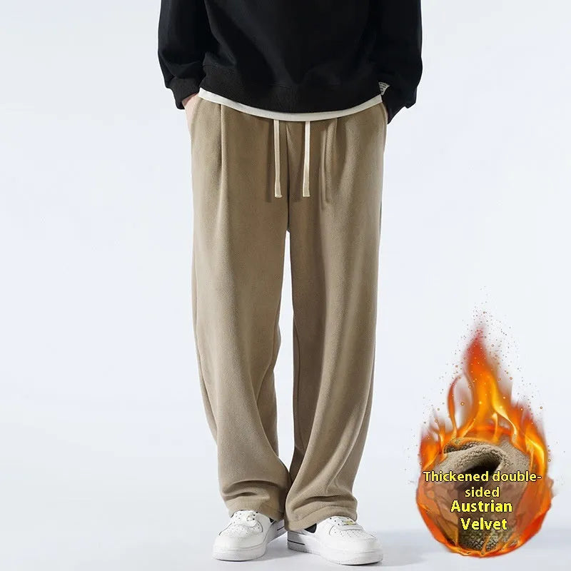 Man wearing apricot coloured loose-fit polar fleece winter sports pants with a drawstring waist.