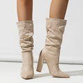 Women's black suede chunky high heel boots with pointed toe and mid-calf length.