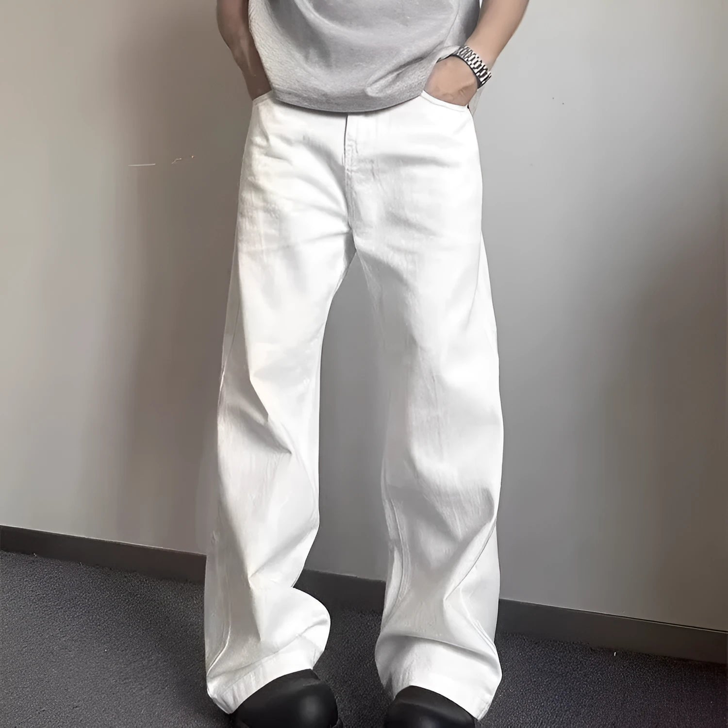 Men's loose fit straight wide leg white cotton denim jeans on a mid waist, showing zipper fly.