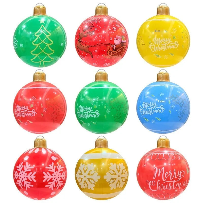 Large red and white inflatable Christmas ball with snowflake design and LED lights in a garden