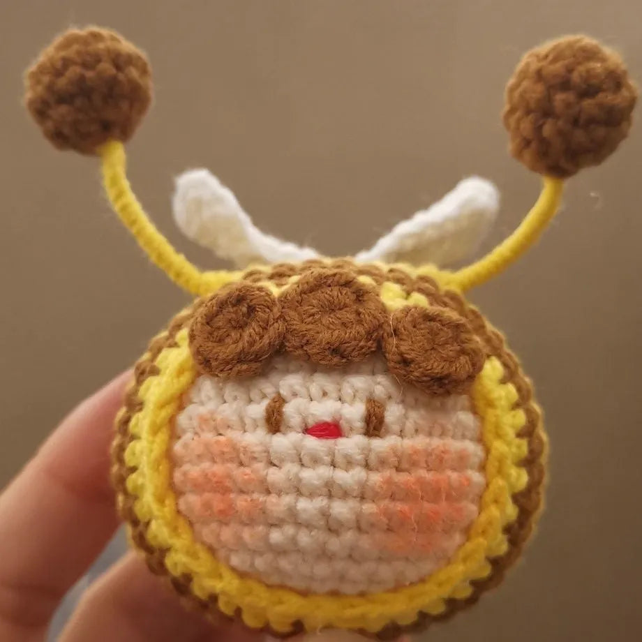 Handmade crocheted bee colony pendant accessory for a woolen doll.