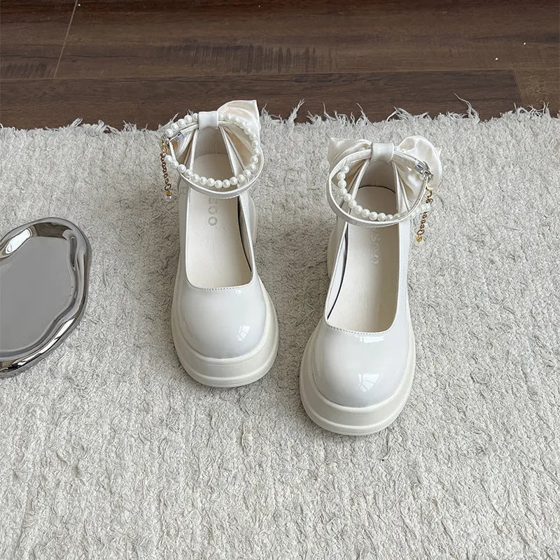 Women's beige chunky heel Mary Jane shoes with a round toe and strap.