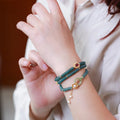Blue water jade abacus bead bracelet with three silver rings and tourmaline pearls