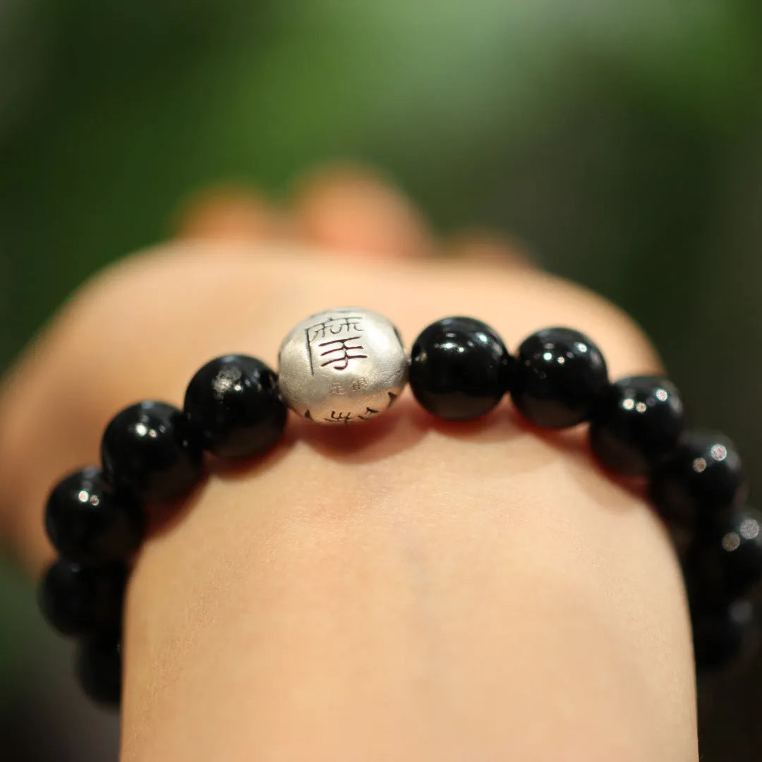 Handmade black agate bead bracelet with sterling silver on a wrist