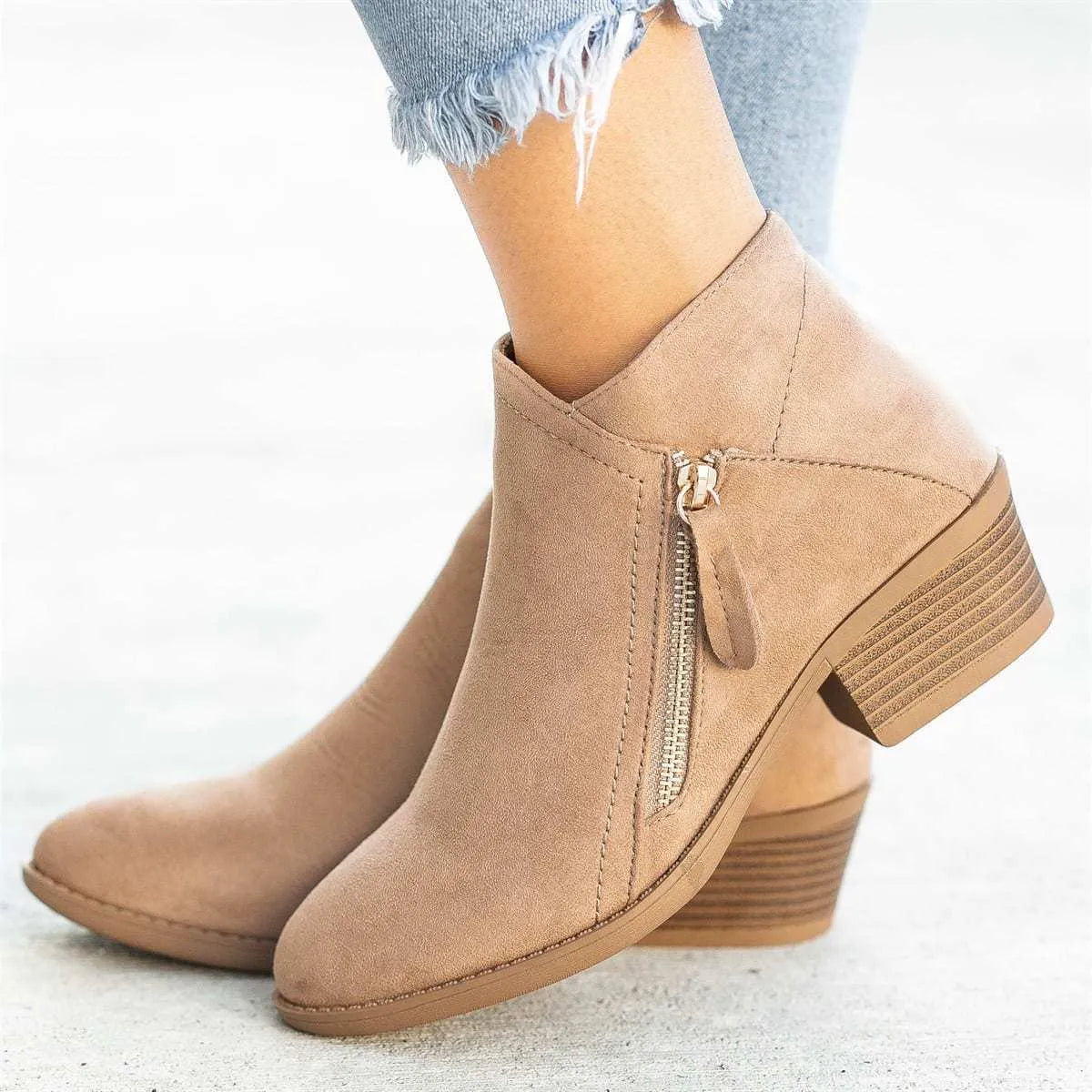 Women's suede ankle boots with side zip and chunky heel in beige, shown from the side.
