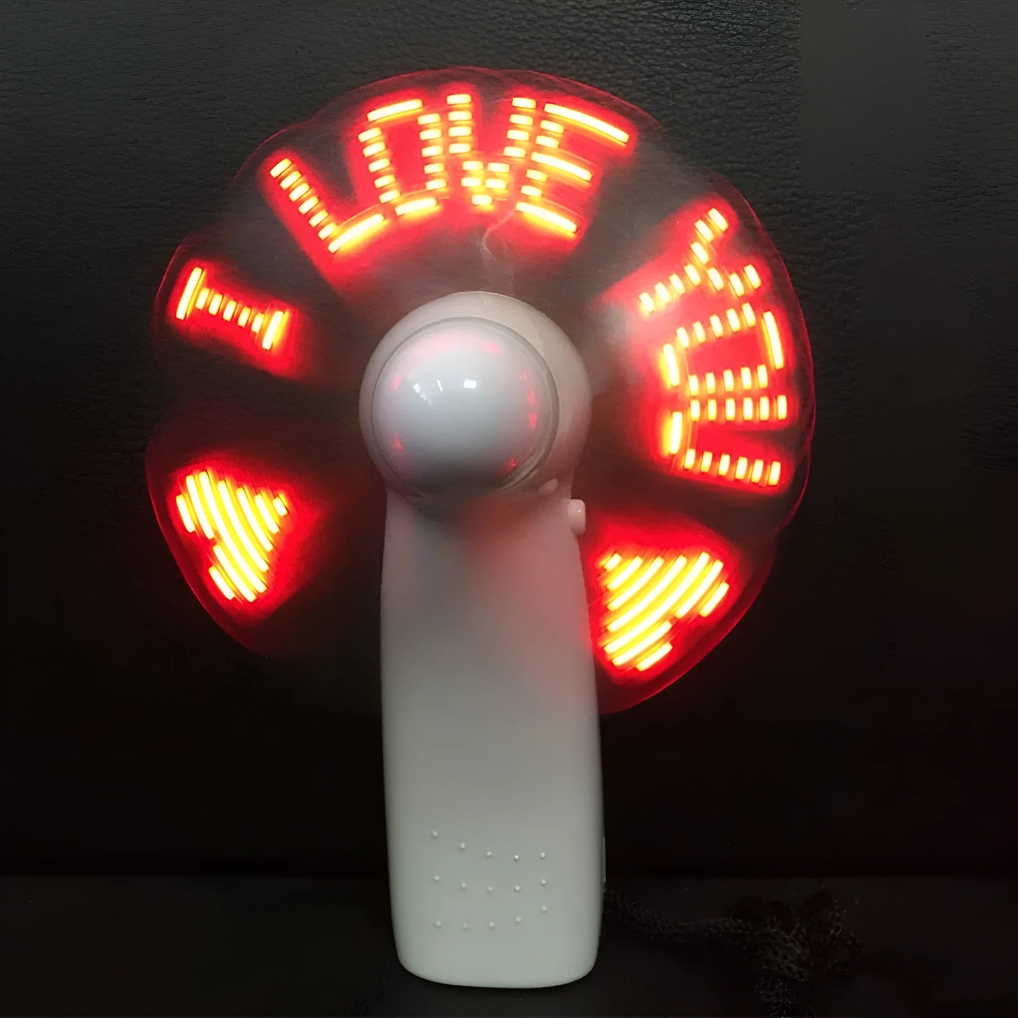 White handheld mini fan displaying a flashing blue and red 'I love you' LED pattern.