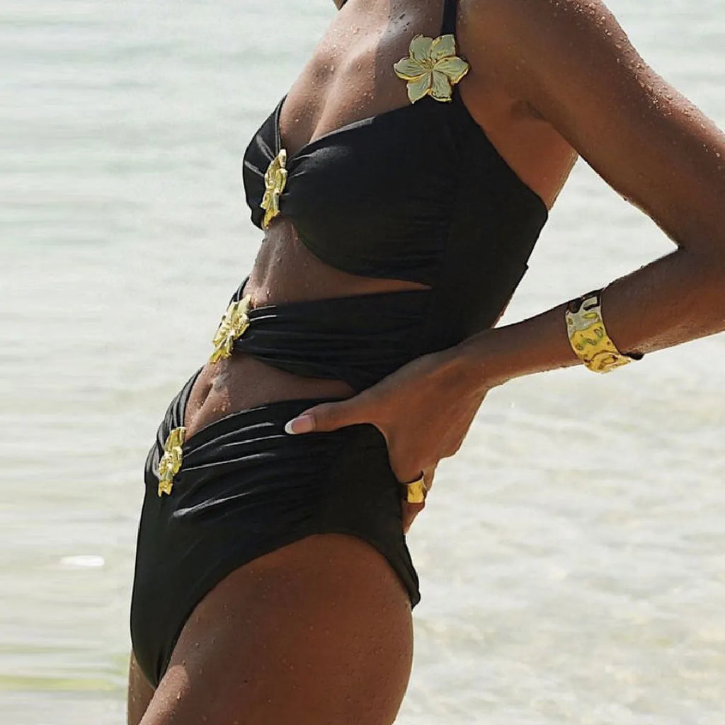 Women's black high-waisted one-piece swimsuit with a detachable short skirt and hollow-out tube top.