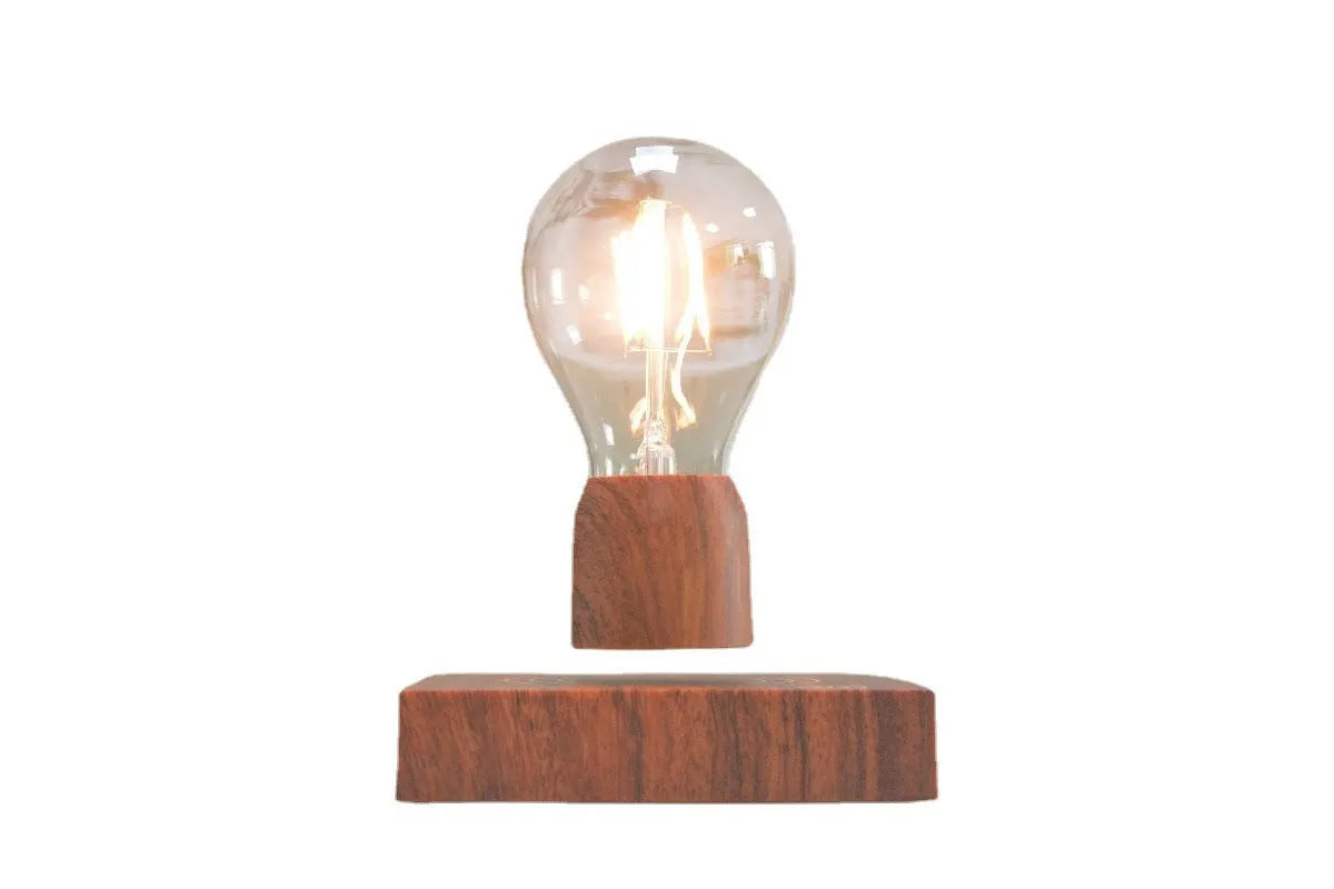 Magnetic levitation floating LED light bulb above an imitation wood base.
