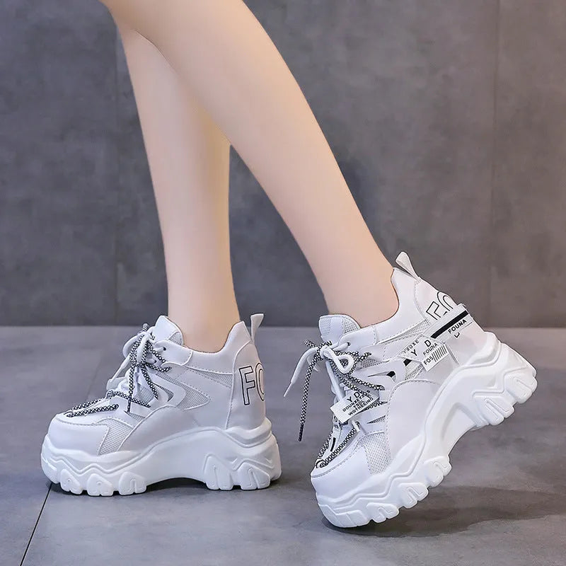 Women's white mesh platform sports shoes with a cross strap and rubber sole.