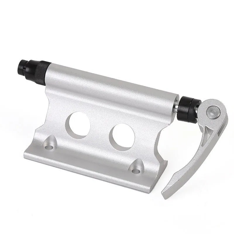 Silver metal quick-release clamp for securing a bicycle front fork during transport.