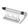 Silver metal quick-release clamp for securing a bicycle front fork during transport.