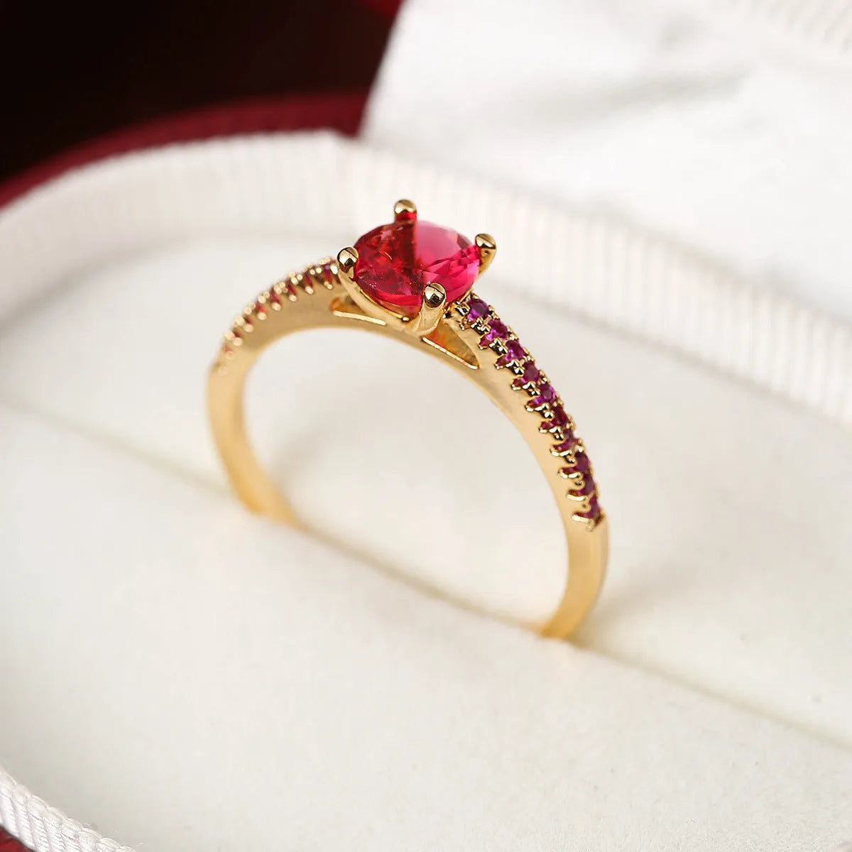 A geometric hexagonal zircon ring in a copper electroplated finish, shown in a gold rose red colour.