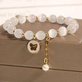 White geometric cat's eye crystal bracelet with a Korean-style design on a wrist.