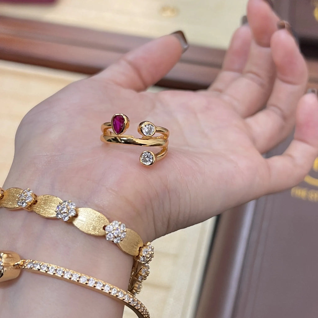 Geometric double-headed ring with irregular cross shape and two-colour electroplated finish