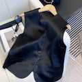 Black satin ladies sleeveless vest with loose fit on hanger