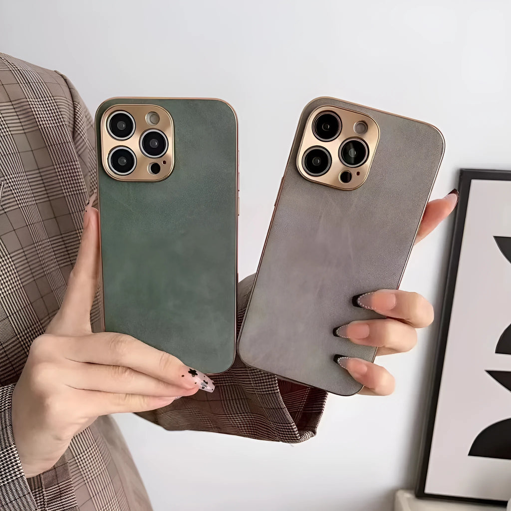 Leather texture solid colour phone case for iPhone on a table, showing black, blue, grey, and grey-green colour options.