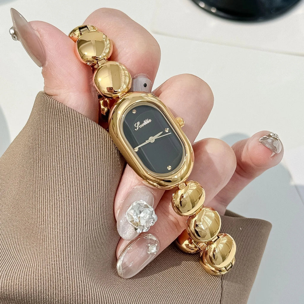Women's oval gold tone watch with bracelet and 9mm case thickness