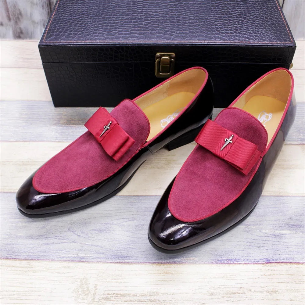 Men's black patent leather low-top dress shoes with a tassel detail on a rubber sole.