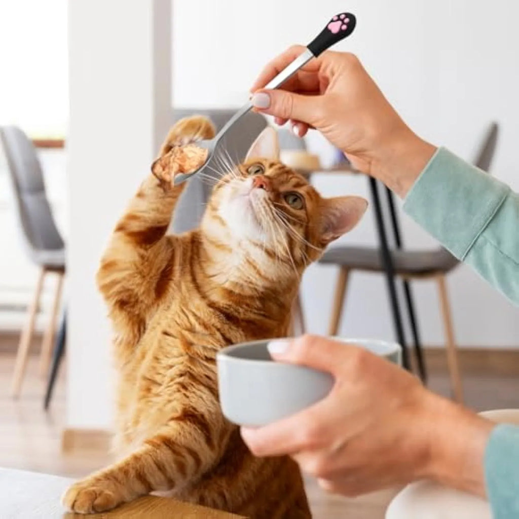 White and black stainless steel pet food spoons with cat paw print and silicone grip