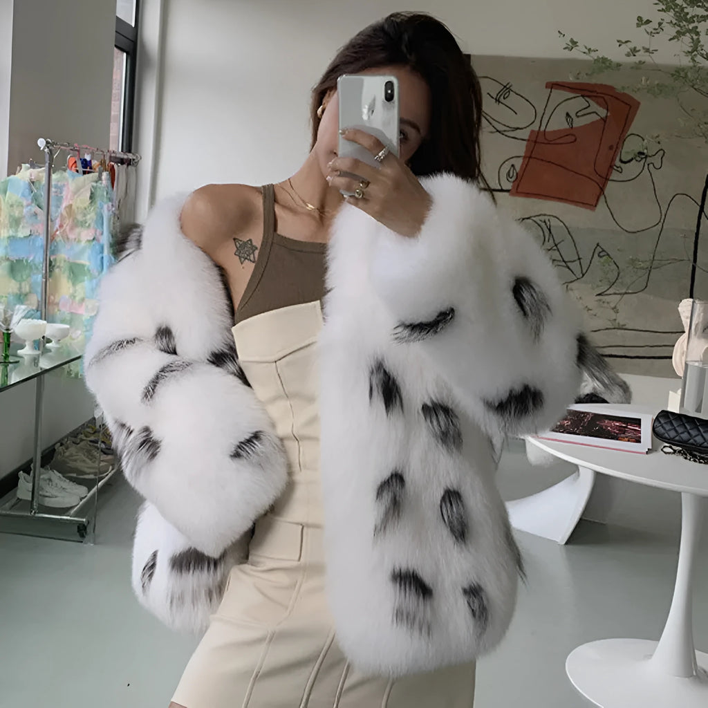 Women's black and white artificial raccoon faux fur coat with slim-fit design and short length.